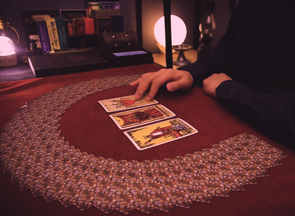 Cards fanned and drawn on a red reading cloth